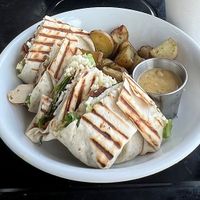 Chicken Caesar wrap. The potatoes were better than the last time I got this, but the sauce looked different; last time, it was more of a spicy tomato and mayo sauce   at Madame Zuzu's in Highland Park