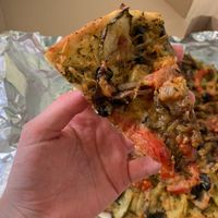 a slice of vegan pizza  at Sansara in Samara