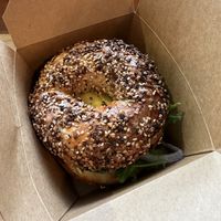 Vegan sausage vegan cheddar arugula everything. Bagel w capers n red onion   at Isaac's Coffee in Salem