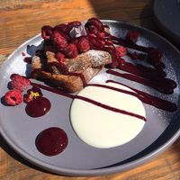 Vegan banana bread with berry compote and vegan yoghurt.  at The Larder in Brixham