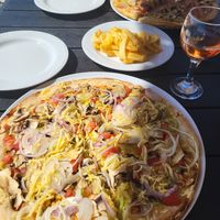 Vegan pizza closest, fries with oregano at Pizza Amici in Thasos