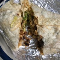 Spicy tofu burrito with beans, cilantro lime rice, lettuce, corn salsa, & guacamole (after surviving a trip home to be enjoyed with vegan sour cream)  at DosBros in Gallatin