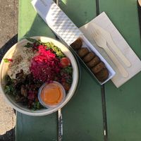 Middle East Salad with falafel, hummus, marinated eggplant, kale, pickled red onion, pomegranate, quinoa and muhamara dip. So fresh and tasty!  at Fafelle in Stockholm