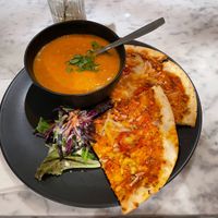 Sweet potato and lentil soup with a couple of pizza slices at Kafé Plattan in Stockholm