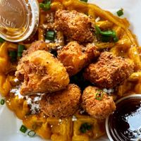 Vegan Chickn and Waffles! Crispy cauliflower chick’n with a sweet potato waffle, served with dipping sauce and maple syrup   at Your Vegan Chef in Dayton