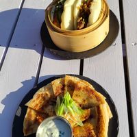 Bao buns (top) and Sour cream & Scallion Pancake (below) at MILA in Vancouver