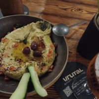 Enormous hummus bowl with deliciously seasoned veggies and warm bread at Vrutal - Poblenou in Barcelona