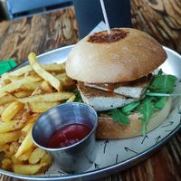Asian Burger: Tamari-marinated grilled tofu, peanut satay sauce, homemade kimchi, mayonnaise, and arugula. at Vrutal - Poblenou in Barcelona