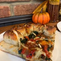 Vegan slice: vegan cheese, spinach, tomato, beyond meat sausage and a garlic knot crust.  at Pat D's Pizza in Howell