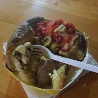 Vegan potato with ajvar (baked.red pepper mash), olives, mushrooms and vegan cheese. at Potato's in Belgrade