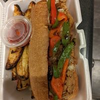 Philly Cheesesteak with potato wedges.  The steak is soy curls at Taste & See in Milledgeville