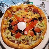 Taco pizza no meat or cheese. I asked and the refried beans are vegan. No lard.  at Tie Dye PIE Pizzaria in Lincoln City