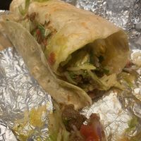 I tried to cut the vegan burrito properly 🫣 It comes very full, and it’s delicious!  at Tortilla House in Helsinki