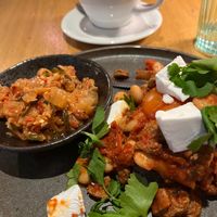 Vegan shakshuka with cilantro, champignons, feta and focaccia, + extra kimchi. at Kolm Tilli in Tartu