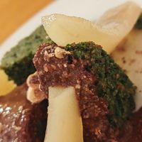 Semolina cake with sunflower seeds, choco hazelnut spread, poached pear, roasted hazelnuts at Sezono in Paris