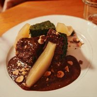 Semolina cake with sunflower seeds, choco hazelnut spread, poached pear, roasted hazelnuts at Sezono in Paris