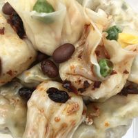 Vegan shao mai and vegan dumplings drenched in their housemade bean chili sauce  at Steamed in Brisbane