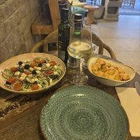 Patatas bravas and Greek salad  at Cinnamon in Sitges