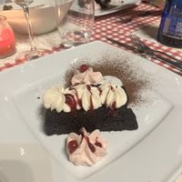 Torta soffice con doppio pan di Spagna al cacao, farcita con marmellata di prugne fatta in agriturismo, accompagnata da crema diplomatica alla vaniglia e salsa ai frutti rossi.  at Agriturismo Biologico La Buona Terra in Cervarese Santa Croce