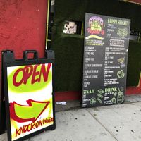 The view from the street.  The little window that you knock on is to the left of the outside menu. at VegainzLA - La Brea in Inglewood