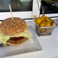 Lentil and Brown Rice Burger with fries. at Kinoa in Malaga