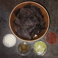 Nachos Azul: Blue corn tortilla nachos topped up with salsa ,pimento cheese and guacamole at Texcoco in Harrow