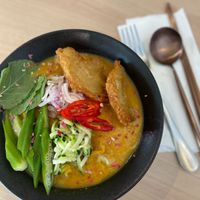 THICK RICE VERMICELLI LAKSA LEMAK RM25
turmeric broth, condiments of laksa, thick rice vermicelli, shaven zucchini
 at Sincerely Crafted Cuisine in George Town