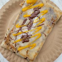 Der Tropical Crêpes mit Bionella, Mangosauce und Kokosraspel at Strandcreperie in Scharbeutz