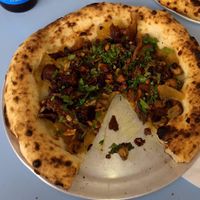 Vegan Pizza: caramelized onions, roasted mushrooms, walnut and raising vinaigrette, mint and lemon zest.  at Lupita Pizzaria in Lisbon