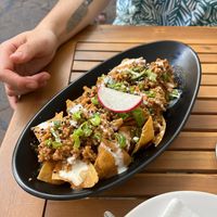 Chilaquiles for sharing - fried corn tortillas with a lot of delicious toppings. at Taqueria La Lupe in Sevilla