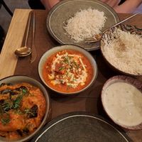 Tofu tikka masala and aloo baingan. Side of raita, and rice at Garlic n Greens in Bruges