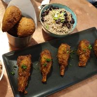Rum chicken wings, coleslaw, rice and peas, sweet pastry at Jam Delish in North London