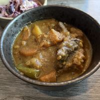 Goat curry and a side of slaw  at Jam Delish in North London