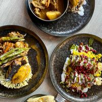 Starting from the left clockwise: codfish & okra, goat curry, jerk chicken, and roti at Jam Delish in North London