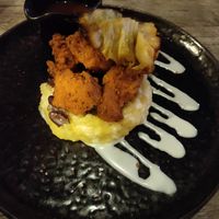 Fried chikin on mash with cabbage and beans at Jam Delish in North London