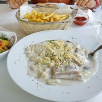 Tagliatelle with mushrooms + french fries and salad !  at Loving Hut in St Kanzian