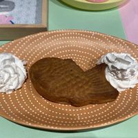 Taiyaki: nice. The outside is a chewy and crispy dough and it contains a nice red bean paste. It’s served with vegan whipped cream.  at Jūshī Café in Rotterdam