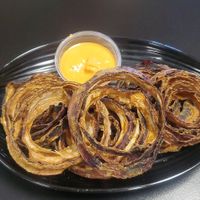 Onion rings with nacho sauce...BOMB!! I could drink the sauce! at Rawk Star Cafe and Marketplace in Oldsmar
