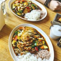 Front: Crispy mock duck (really mock chicken imho) with fresh veggies and a chili ginger sauce.
Back: wok veggies with mock chicken in hoisin sauce.
Both with two types of rice. at Well Being in Cologne
