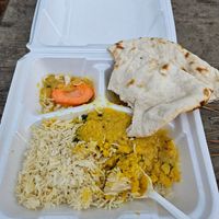 Lentils with the accompanying rice, Flatbread, and carrot slice. at Taste of India Bar & Grill in Texarkana