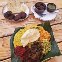 Weekday curry plate, pigeon pea fritters, paper-thin bread, green sauce (a must!) And eggplant. at Mirisata in Portland