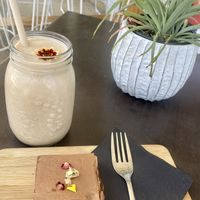 Banana, cacao and peanut butter smoothy ($8) and vegan choc mint slice ($6.50) - delicious!   at OWL Wholefoods in Canungra