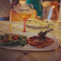 Cheese-free Lasagna with salad greens at Historic Route 66 Pub in Caltanissetta