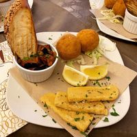 Traditional Sicilian cuisine - Aubergine Caponata, veggie Arancini Rice Balls, and Panelle (chickpea fritters) at Historic Route 66 Pub in Caltanissetta