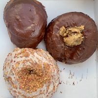 Boston creme, cookie dough and Cap’n Crunch  at Sojo's Donuts in Mesa
