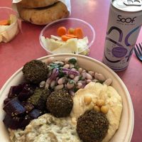 Mezze bowl: hummus, white bean salad, baba ganoush, beetroot with a delicious herb and falafels. Vegetables on the side and home-baked pita.   at Levantini in Maastricht