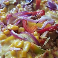 Vegan BBQ pizza with vegan chicken filet, vegan BBQ sauce, corn, onions and sweet pepper at Domino's Pizza in Frankfurt