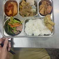 tofu on tomatoes on the left, noodless and spring rolls in the middle, sweet and sour tofu on the right, veggies and rice at the bottom  at Ngoc Y in Ho Chi Minh City