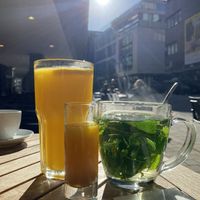 Freshly squeezed orange juice, immune defense ginger shot and fresh mint tea  at Cotidiano in Stuttgart