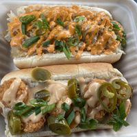 The breakfast dog on the left which is this week’s special. Vegan dog topped with sausage gravy, tots, chz, and jalapeños. The Jon Stewart which is always on the menu on the rig at Frankly Plant Based Kitchen in Toledo